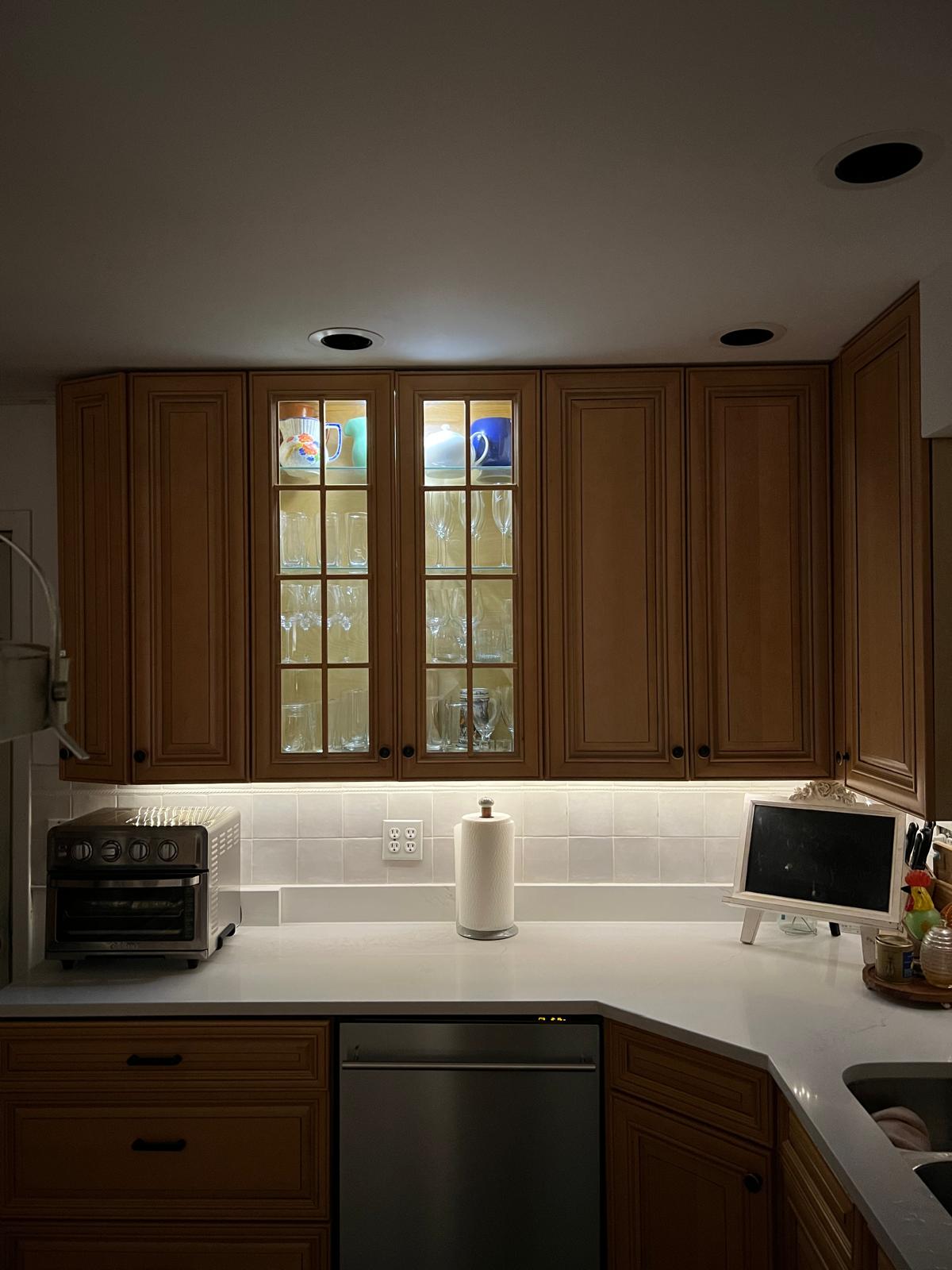 Oak kitchen cabinets and a white countertop