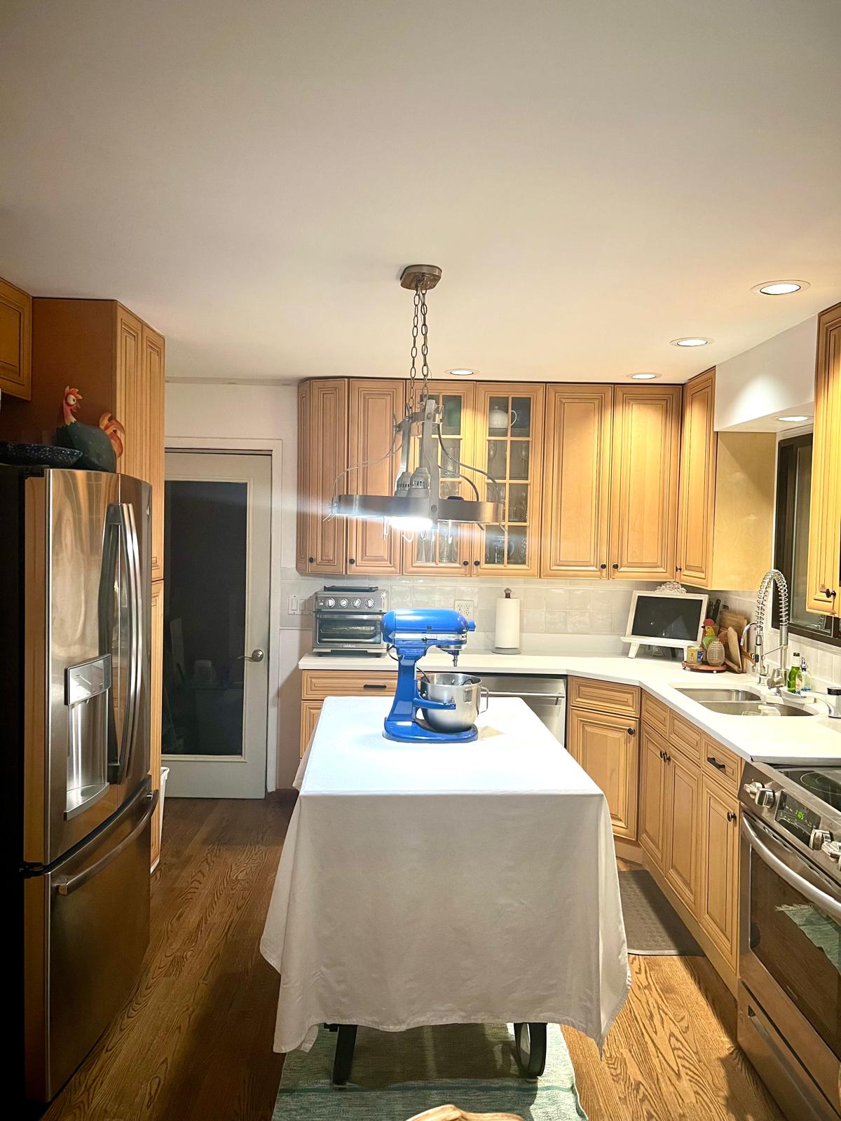 Eat-in kitchen with oak cabinets, a center island, and stainless appliances