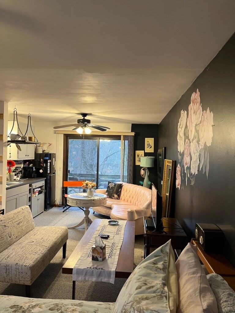 Studio living area with a kitchenette and balcony doors